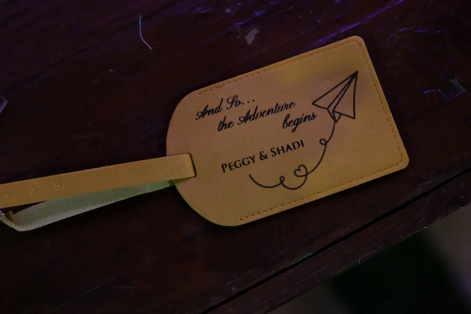Personalised leather luggage tag reading And So the Adventure Begins